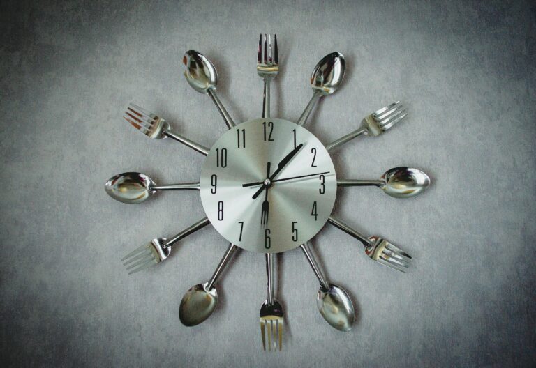 Unique wall clock made of stainless steel cutlery in an artistic layout.